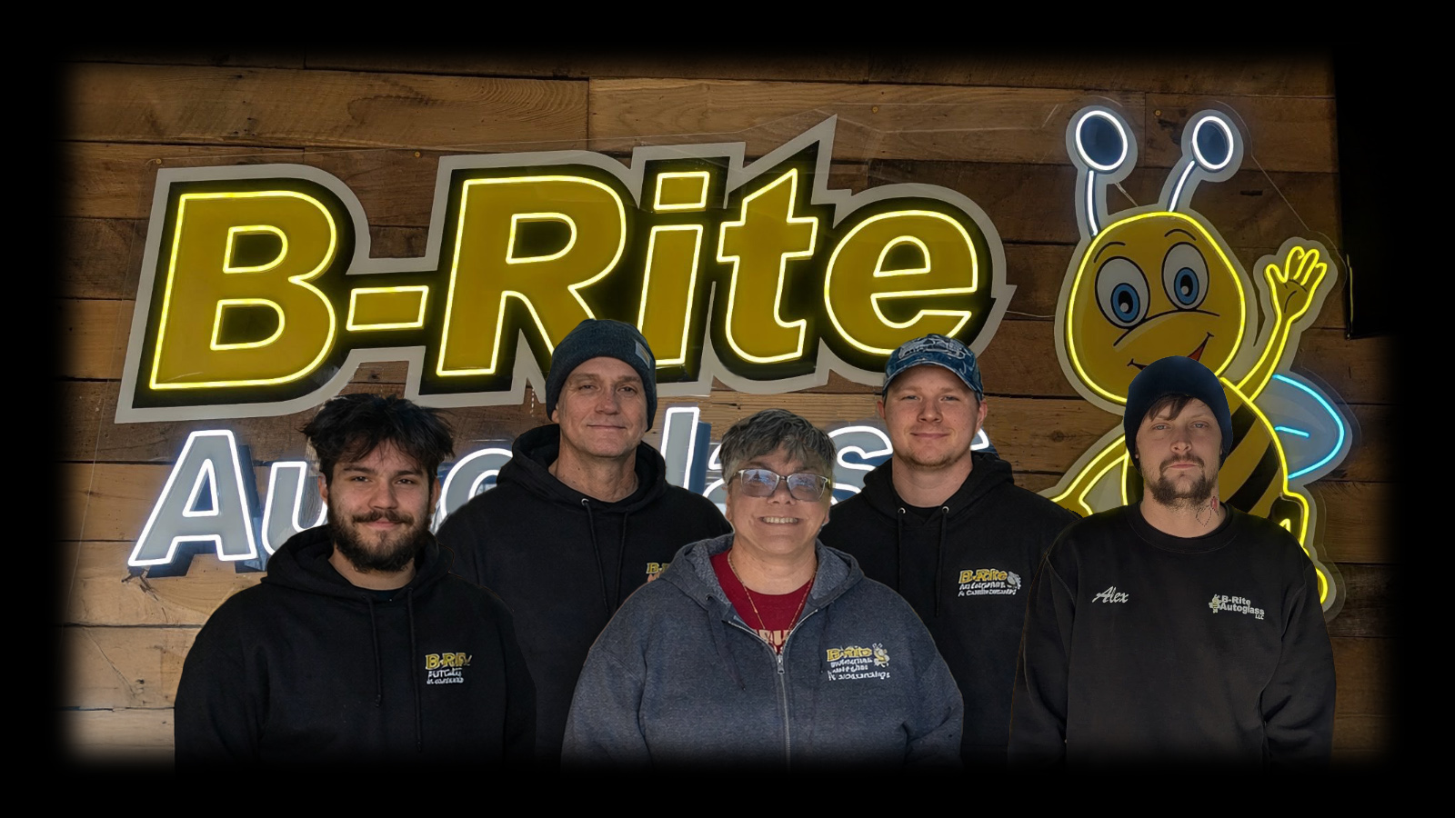 The B-Rite Autoglass team of six standing in front of the B-B-Rite Autoglass sign and bee mascot at the Madison IN shop