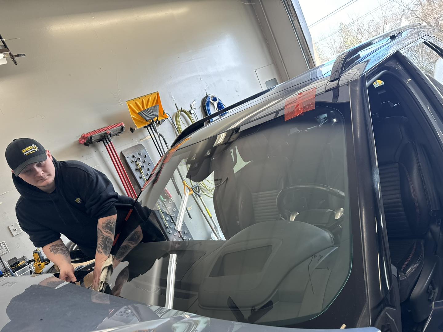 B-Rite technician finishing a windshield installation in the Madison IN shop